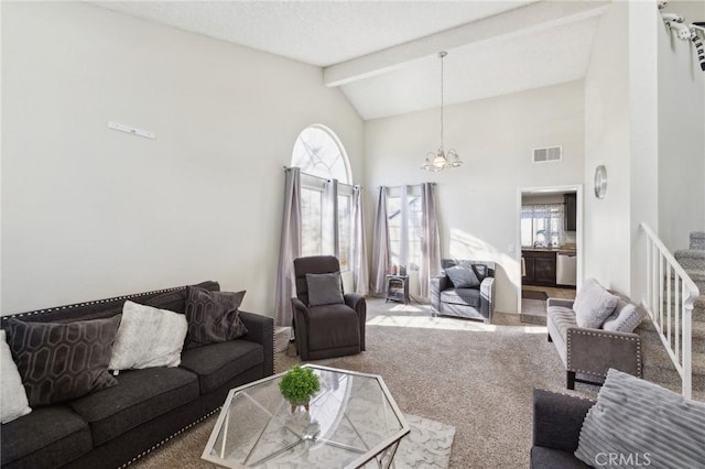 carpeted living room with high vaulted ceiling, a healthy amount of sunlight, and beam ceiling