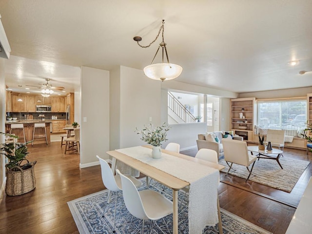 dining area featuring ceiling fan and dark hardwood / wood-style flooring