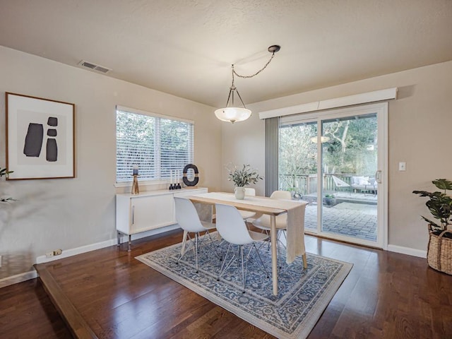 dining area with dark hardwood / wood-style floors