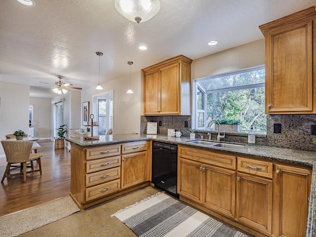 kitchen with sink, black dishwasher, tasteful backsplash, decorative light fixtures, and kitchen peninsula