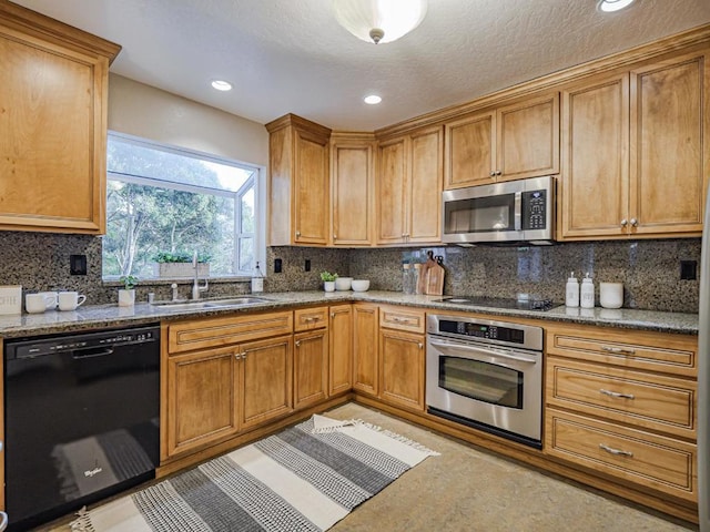 kitchen with sink, backsplash, black appliances, a textured ceiling, and stone countertops