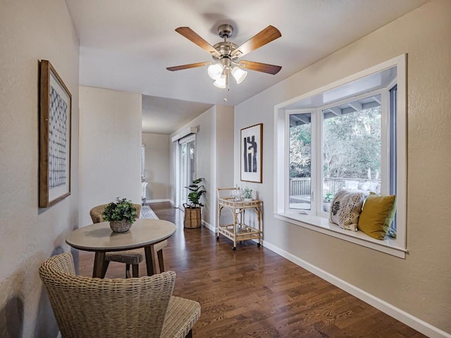 interior space with dark wood-type flooring and ceiling fan