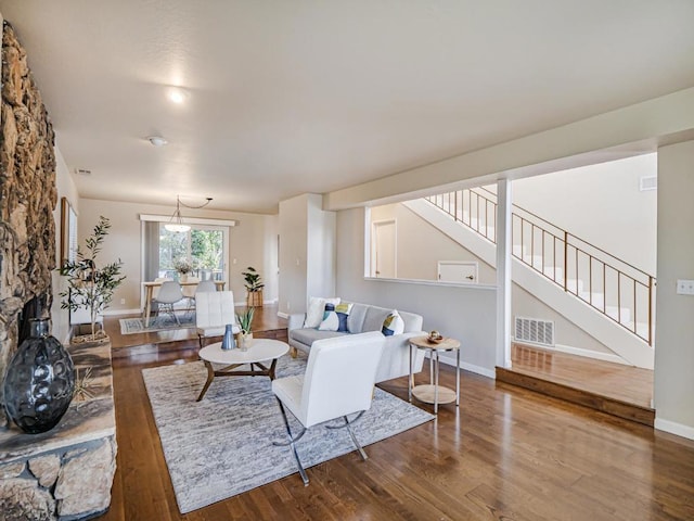 living room with hardwood / wood-style floors and a fireplace