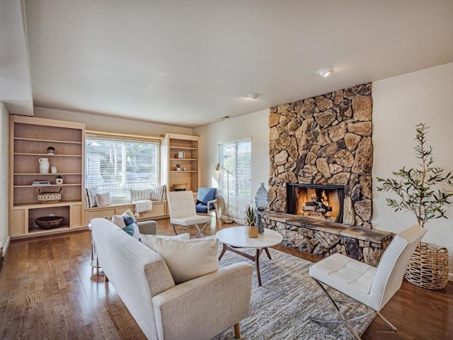 living room with wood-type flooring and a fireplace