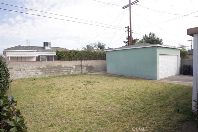 view of yard featuring a garage and an outdoor structure