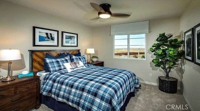 bedroom featuring ceiling fan and light carpet