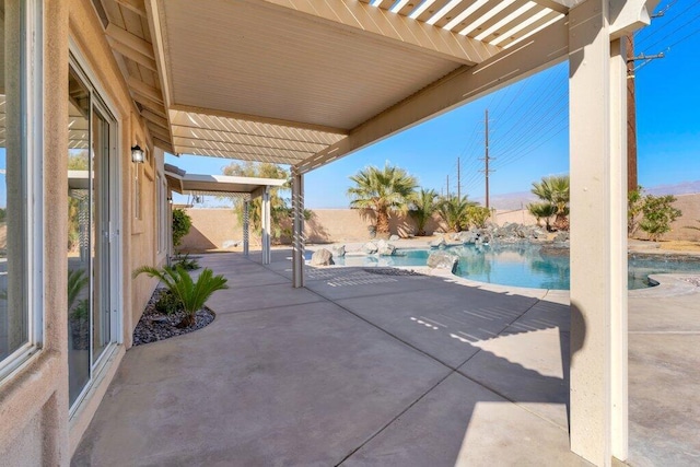 view of patio featuring a fenced in pool and a pergola