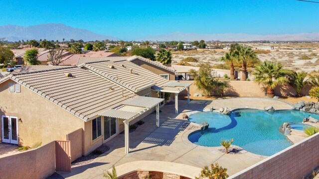 view of swimming pool featuring a mountain view and a patio area