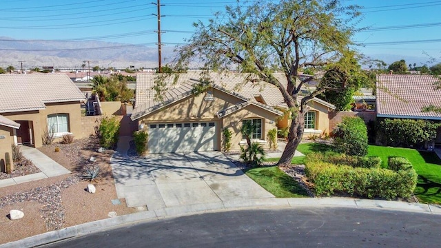 view of front facade with a mountain view and a garage