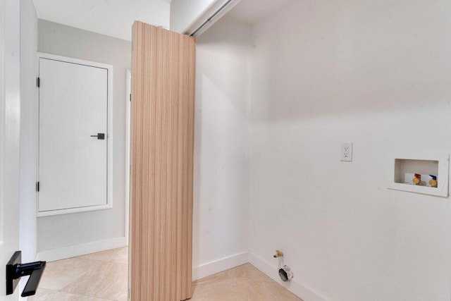 clothes washing area with washer hookup and light tile patterned floors