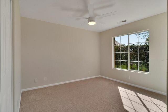 carpeted empty room featuring ceiling fan