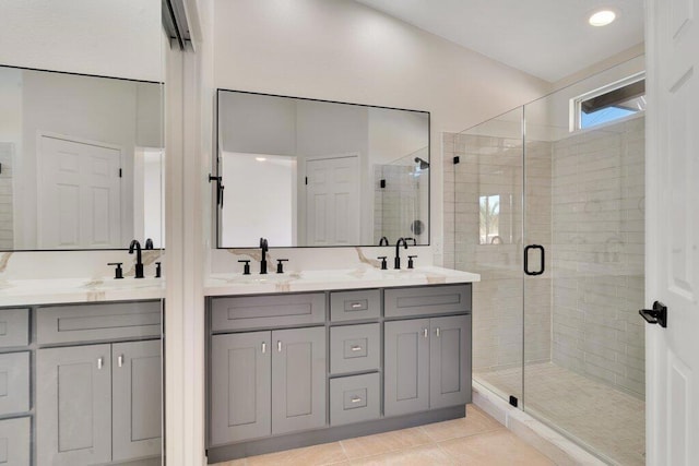 bathroom with an enclosed shower, vanity, and tile patterned floors