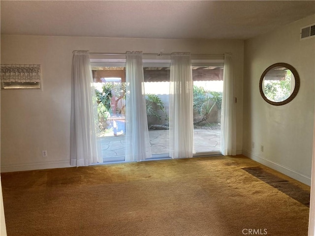 doorway with a healthy amount of sunlight and carpet flooring