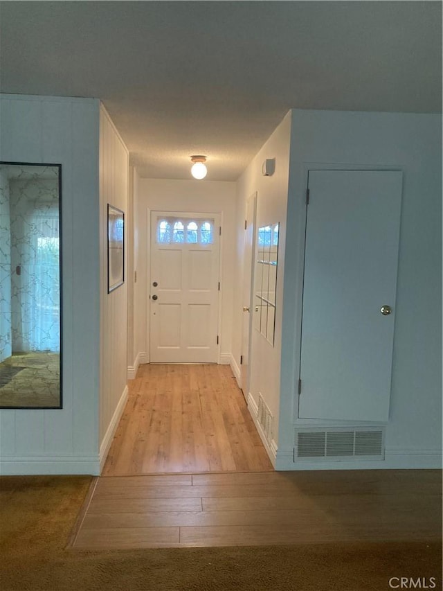 entryway with light hardwood / wood-style floors