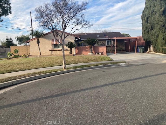 single story home featuring a carport and a front lawn