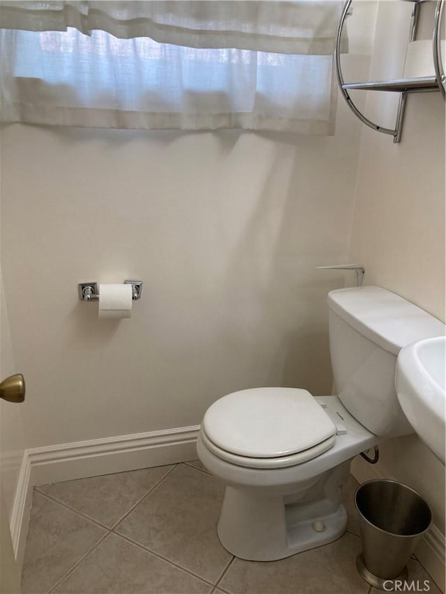 bathroom featuring tile patterned flooring and toilet