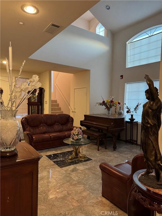 living room with a towering ceiling