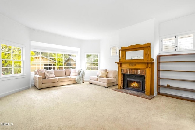 living room featuring a brick fireplace and carpet