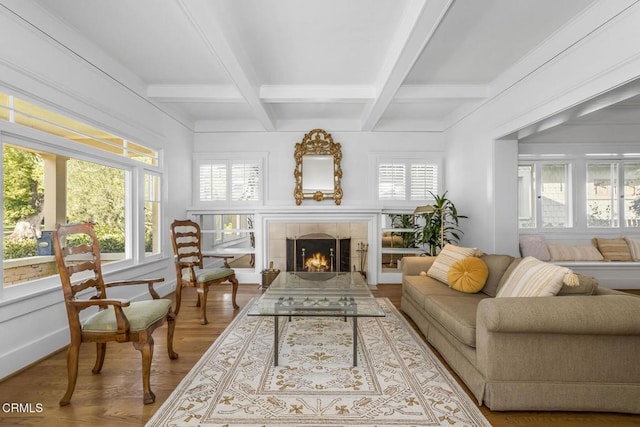 sunroom / solarium with a tiled fireplace, beam ceiling, plenty of natural light, and coffered ceiling