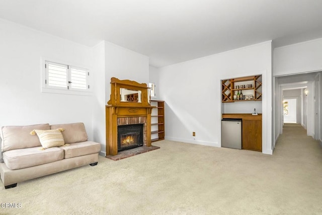 carpeted living room featuring bar and a brick fireplace