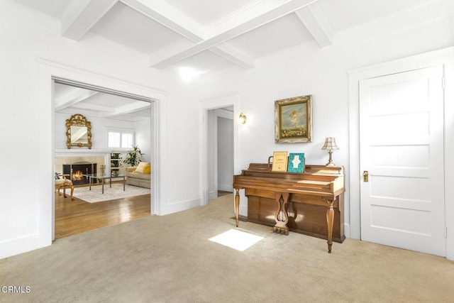 miscellaneous room featuring light carpet and beam ceiling