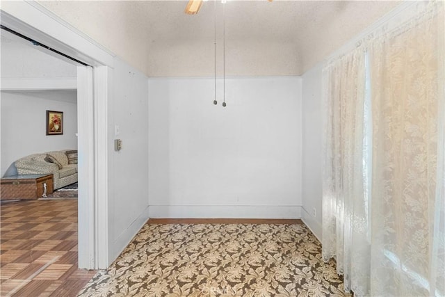 interior space featuring parquet flooring and ceiling fan