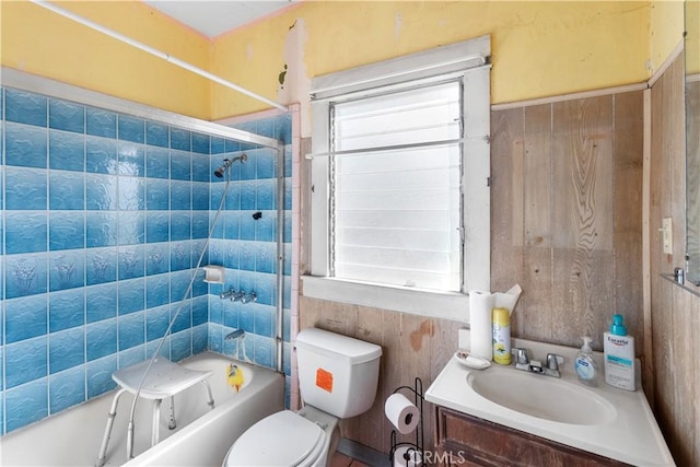 full bathroom with tiled shower / bath combo, vanity, plenty of natural light, and toilet