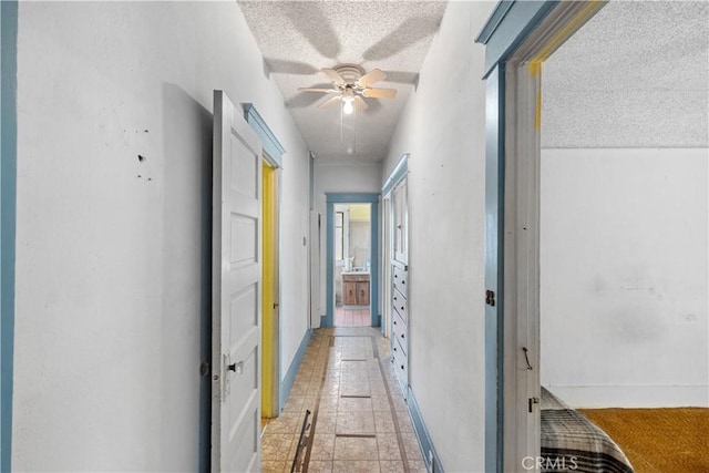 corridor featuring a textured ceiling