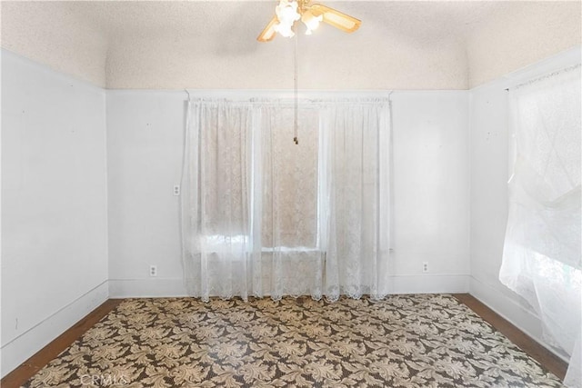 unfurnished room featuring ceiling fan and a healthy amount of sunlight