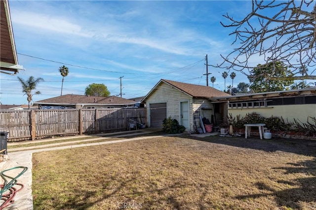 view of yard with a garage and an outdoor structure