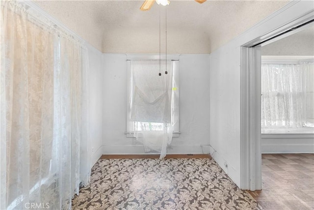 interior space with ceiling fan and a textured ceiling