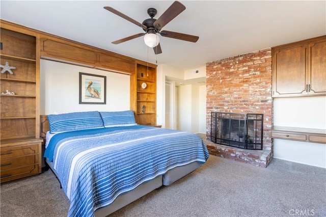 bedroom with ceiling fan, a fireplace, visible vents, and carpet flooring