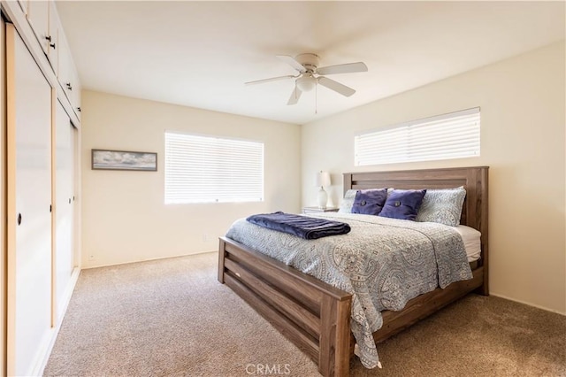 carpeted bedroom featuring a closet and ceiling fan