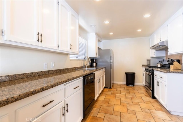 kitchen with under cabinet range hood, stainless steel appliances, a sink, white cabinetry, and dark stone counters