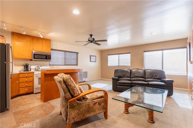 living area featuring light tile patterned floors, recessed lighting, ceiling fan, track lighting, and baseboards