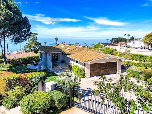 6130 Terryhill Dr, La Jolla, CA 92037 - view of front of property featuring stucco siding, concrete driveway, an attached garage, and a gate