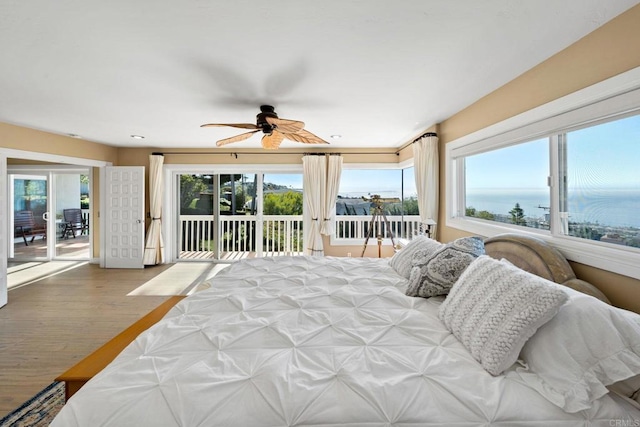 6130 Terryhill Dr, La Jolla, CA 92037 - bedroom featuring access to exterior, multiple windows, a water view, and wood finished floors