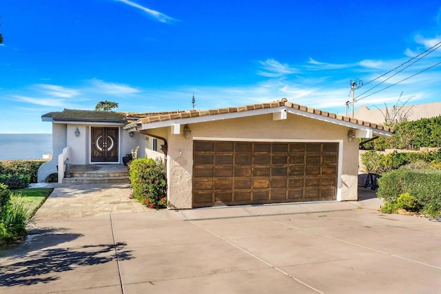 6130 Terryhill Dr, La Jolla, CA 92037 - view of front of house with stucco siding, concrete driveway, and an attached garage