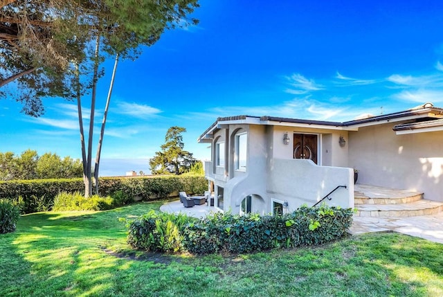 6130 Terryhill Dr, La Jolla, CA 92037 - view of home's exterior featuring stucco siding, a yard, and a patio area
