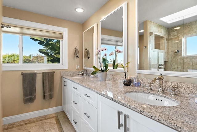 6130 Terryhill Dr, La Jolla, CA 92037 - full bath with a tile shower, baseboards, double vanity, recessed lighting, and a skylight