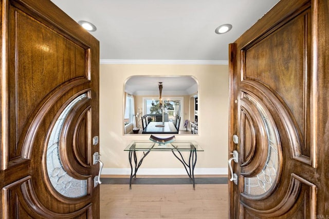 6130 Terryhill Dr, La Jolla, CA 92037 - foyer with arched walkways, baseboards, wood finished floors, crown molding, and recessed lighting