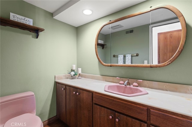 bathroom featuring vanity and toilet