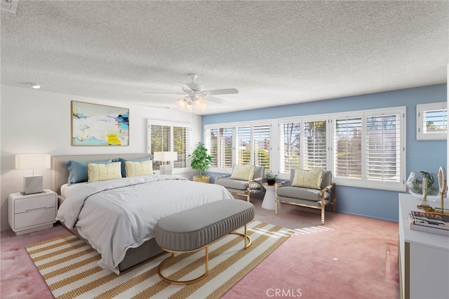 carpeted bedroom with a textured ceiling and ceiling fan