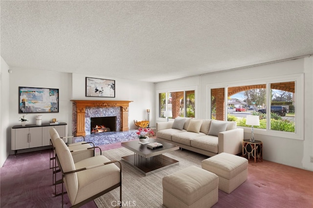 carpeted living room featuring a fireplace and a textured ceiling