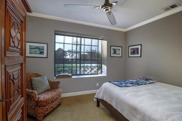 carpeted bedroom with crown molding and ceiling fan