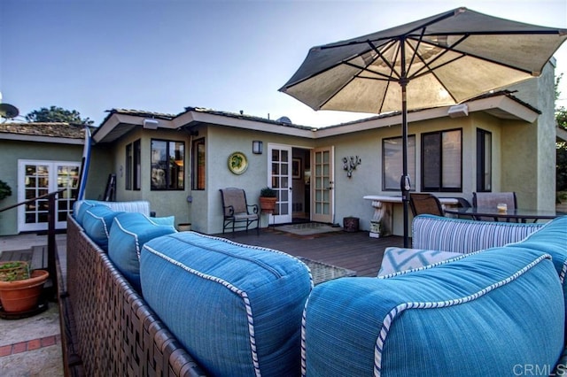 view of patio with a wooden deck, outdoor lounge area, and french doors