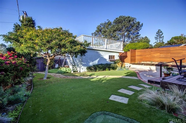 view of yard featuring a patio and a deck