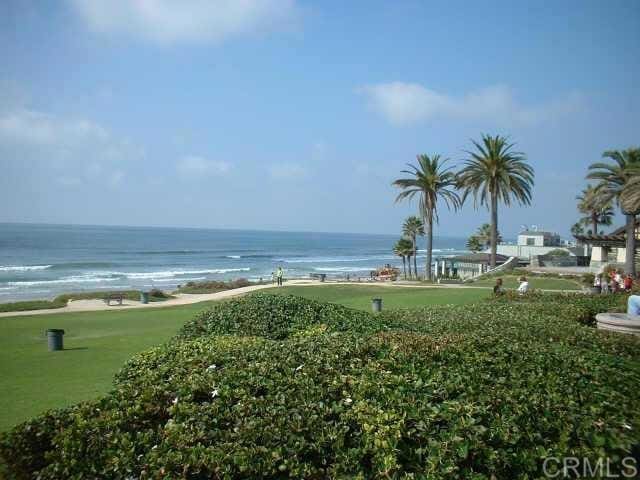 view of home's community featuring a water view and a lawn