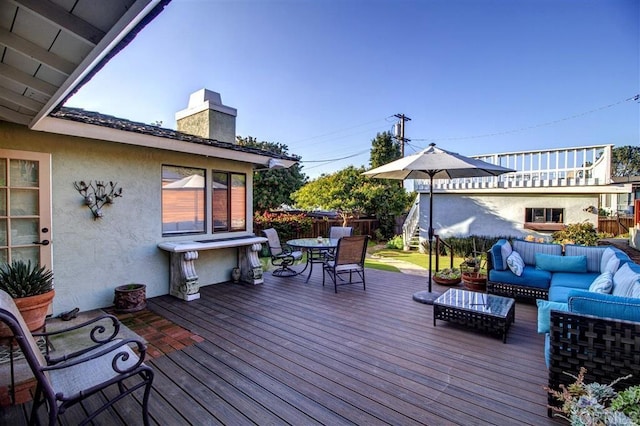 wooden terrace with an outdoor living space