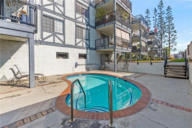 view of swimming pool with a patio area